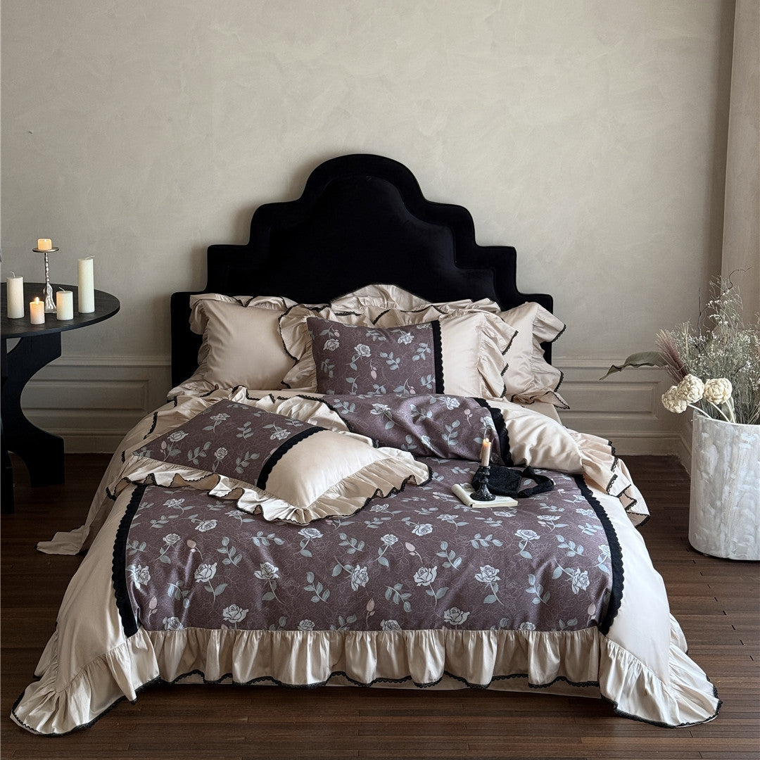 Front view of dusty mauve TENCEL bedding set styled with candles
