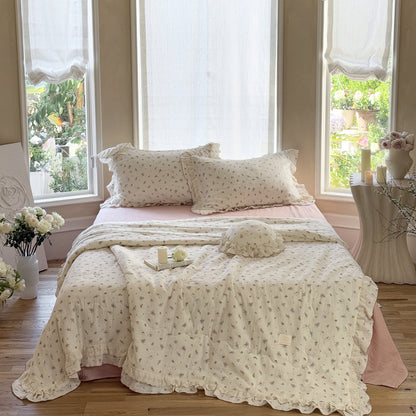 Lightweight floral cotton comforter layered with soft gauze bedding