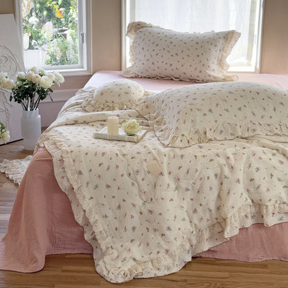 Close-up of romantic floral cotton comforter with vintage ruffles