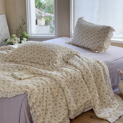 Close-up of floral cotton comforter with romantic ruffle and soft texture