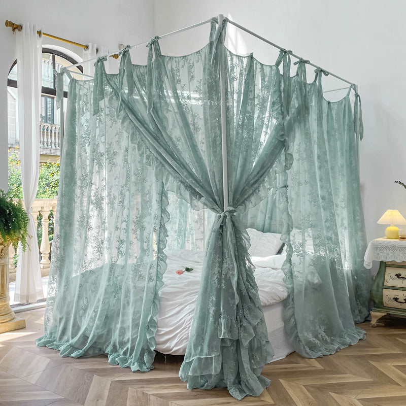 Elegant 4-poster bed with floral lace ruffle canopy curtains in a bright, airy bedroom with white bedding