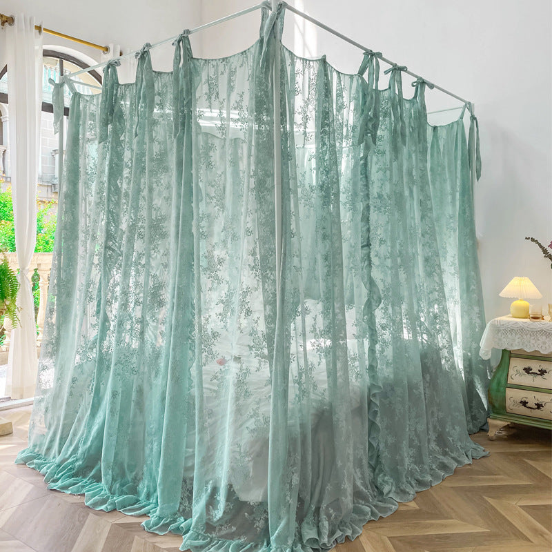 Elegant light blue floral lace canopy curtains on a four-poster bed in a bright, airy bedroom