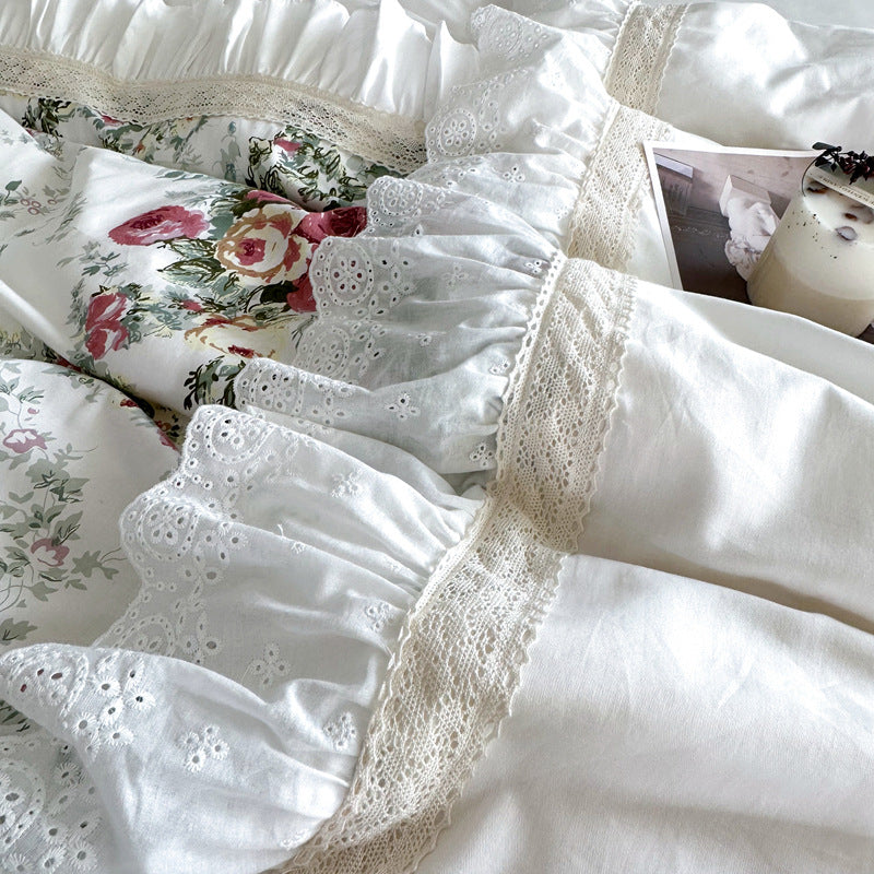 Close-up of lace and ruffled trim on French rose cotton bedding