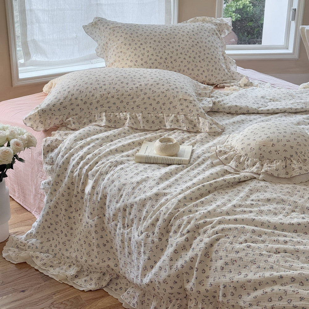 Close-up of soft cotton bedding with small flower pattern and delicate gathered edges