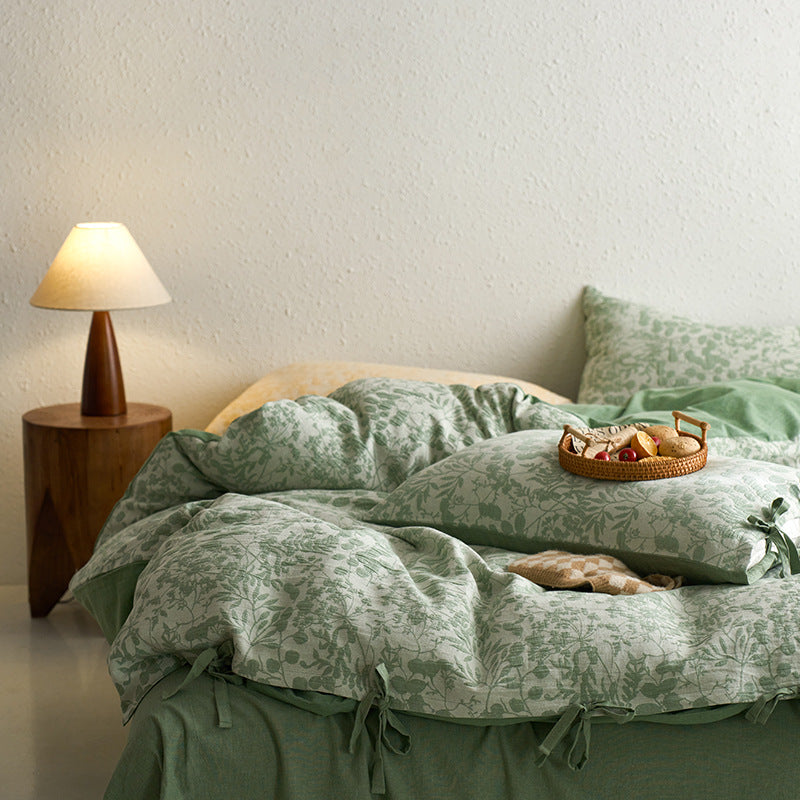 Green jacquard bedding styled in a soft cozy setup with reversible duvet cover