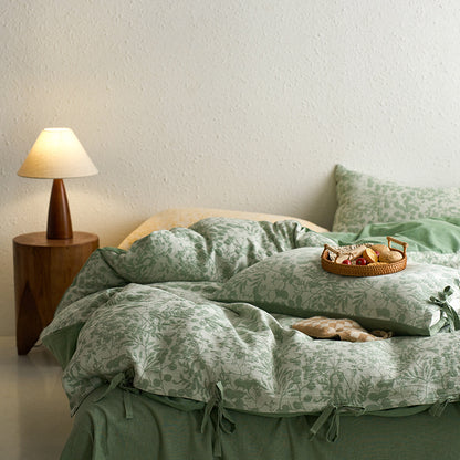 Green jacquard bedding styled in a soft cozy setup with reversible duvet cover