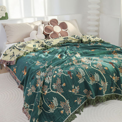 Hummingbird jacquard cotton blanket styled on a bed