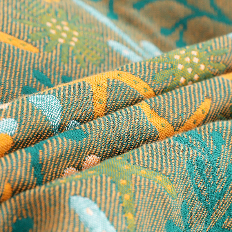 Extreme close-up of the textured jacquard weave, demonstrating the durable and skin-friendly cotton material of the reversible ocean blanket.