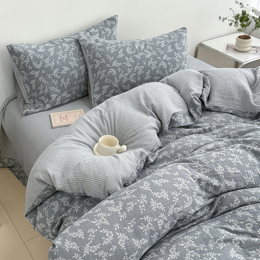A detailed close-up of the grey 100% Cotton Jacquard Duvet Cover Set showing the intricate Leaf Pattern and the reversible gingham weave.