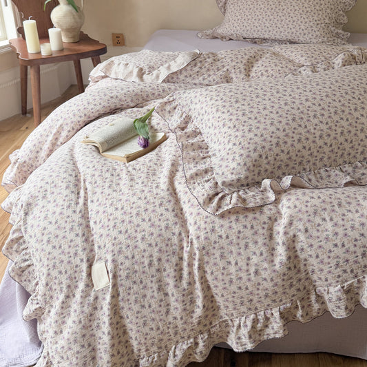 Lavender floral cotton duvet with ruffles, close-up of floral trim and stitching detail