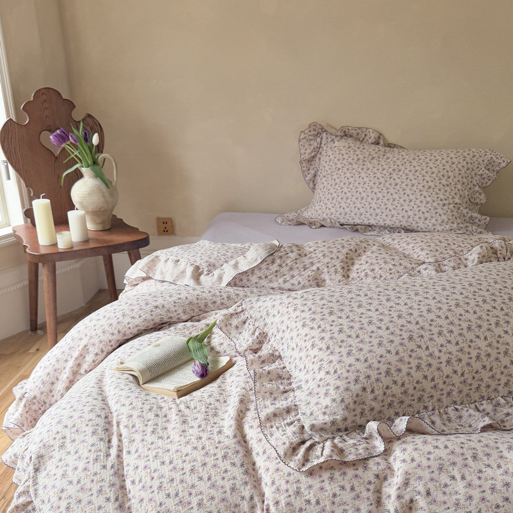 Soft lavender floral bedding set on bed with tulip and book, showcasing relaxed lifestyle