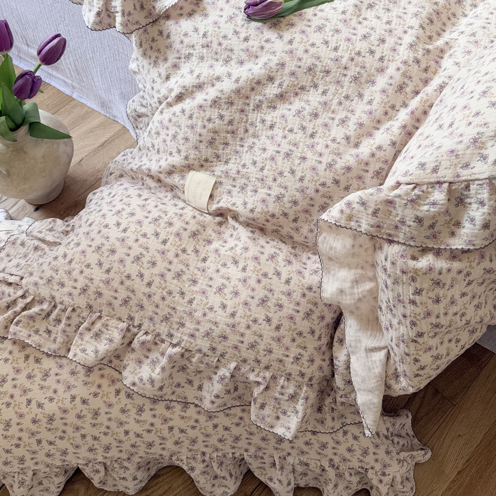 Ruffled duvet cover and matching pillow on bed, in soft gauze cotton texture