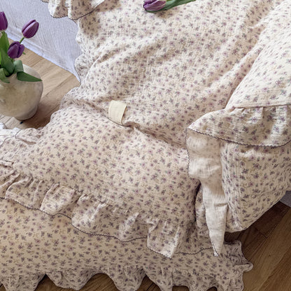 Ruffled duvet cover and matching pillow on bed, in soft gauze cotton texture