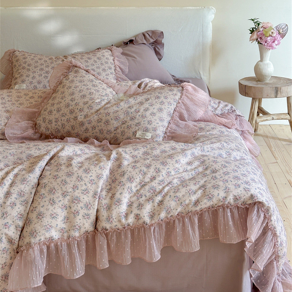 side view of the lavender floral ruffled bedding: Focuses on the layered details at the corner of the bed, emphasizing the three-dimensional feel and romantic pleats of the multi-layered ruffled pillow shams and bed sheet.