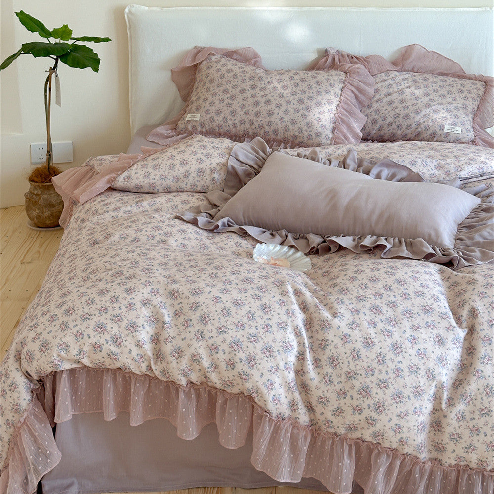 Full view of the Lavender Floral Ruffled Cotton Gauze Bedding Set: Complete display of the bed, including the duvet cover with a sheer ruffled edge, two floral pillow shams, and a solid-colored rectangular bolster pillow, creating a sweet cottagecore aesthetic.