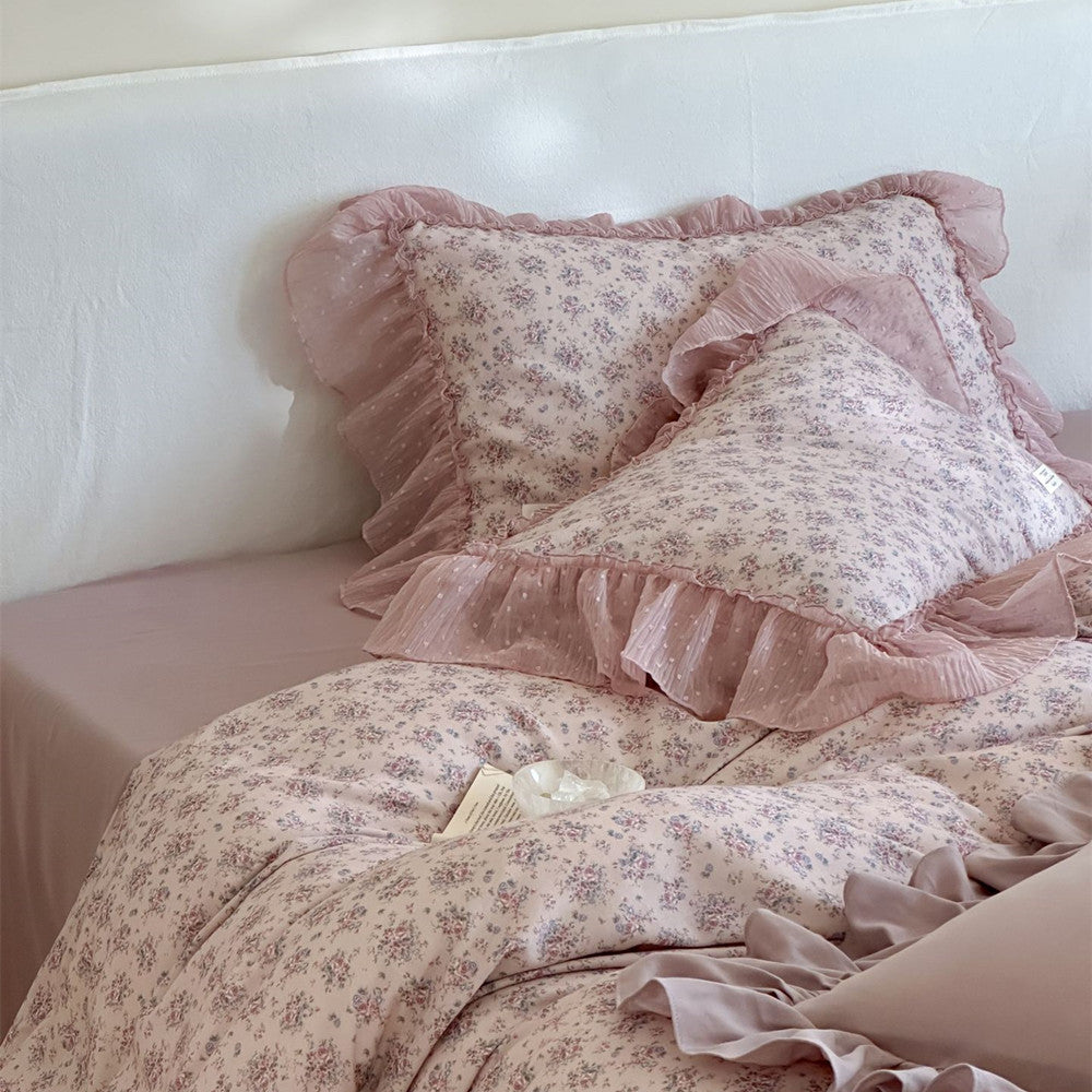 Close-up detail of the Lavender Floral Ruffled Cotton Gauze Bedding: Focus on the pink dotted sheer ruffle on the floral pillow sham and duvet cover, showcasing the delicate floral print and the layered texture of the fabric.