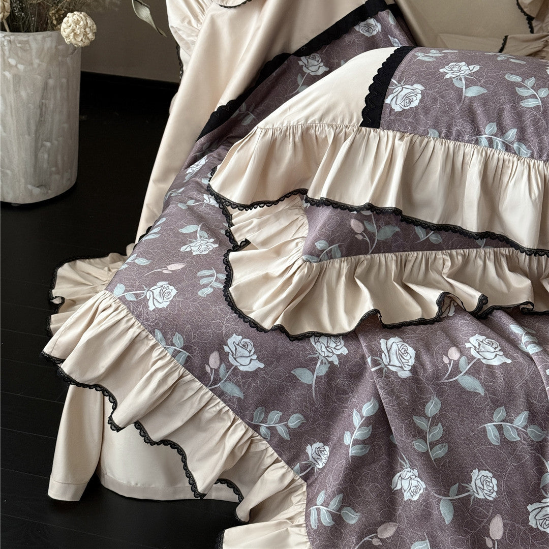 Close-up of layered ruffles and floral print on dusty mauve TENCEL comforter