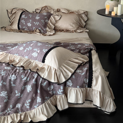 Dusty mauve floral comforter set with ruffled edges and soft luster