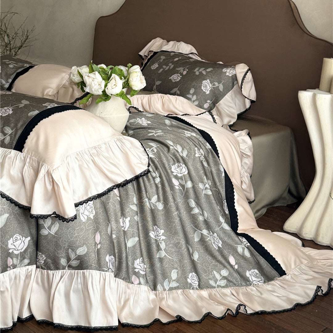 Close-up of olive gray rose floral print and silky ruffle fabric