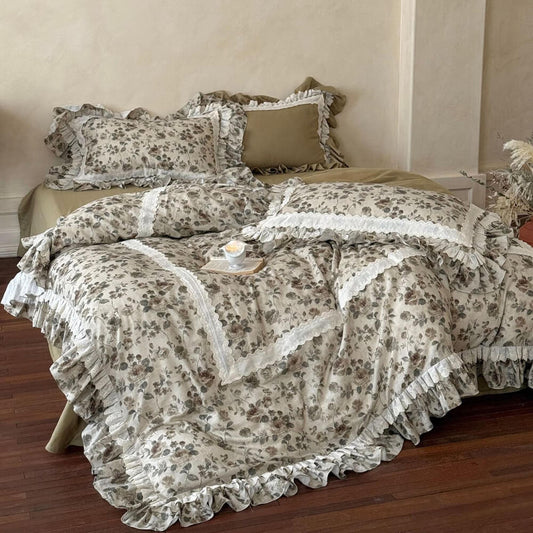 Vintage floral ruffle bedding set with muted olive and taupe flowers, ivory lace trim, and layered French cottage styling