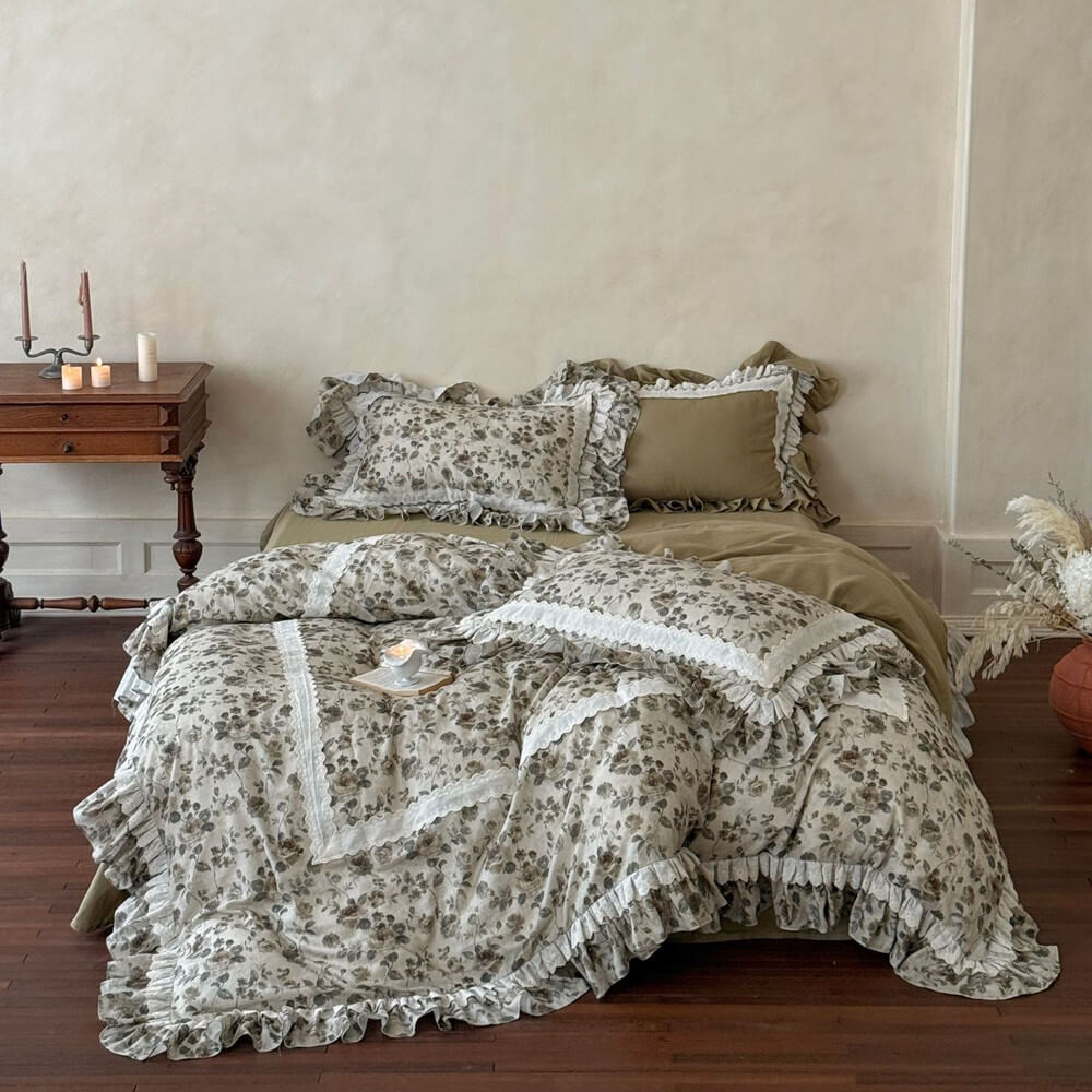 Olive vintage floral bedding set with layered ruffles, lace-trimmed pillows, and soft French country bedroom styling