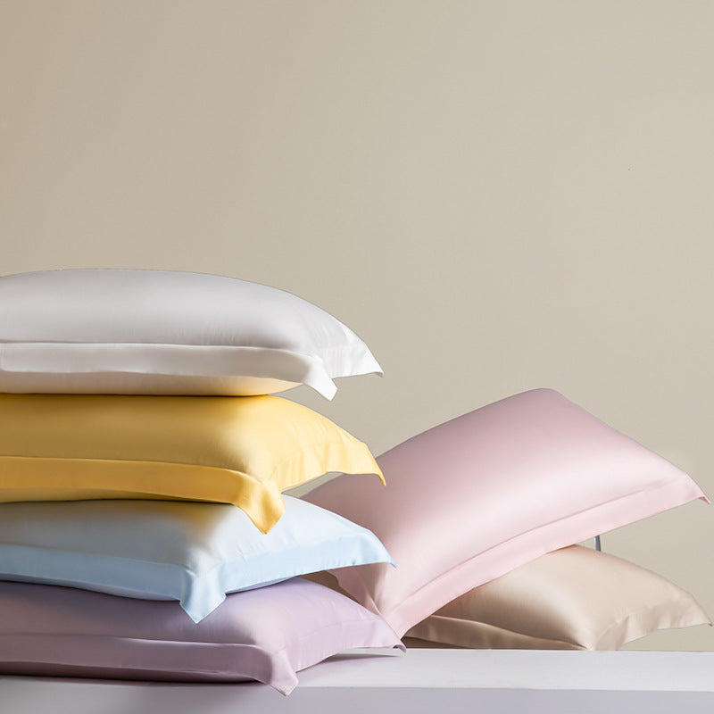 Stack of silky TENCEL Lyocell cooling pillowcases in pastel colors from StuffedHome