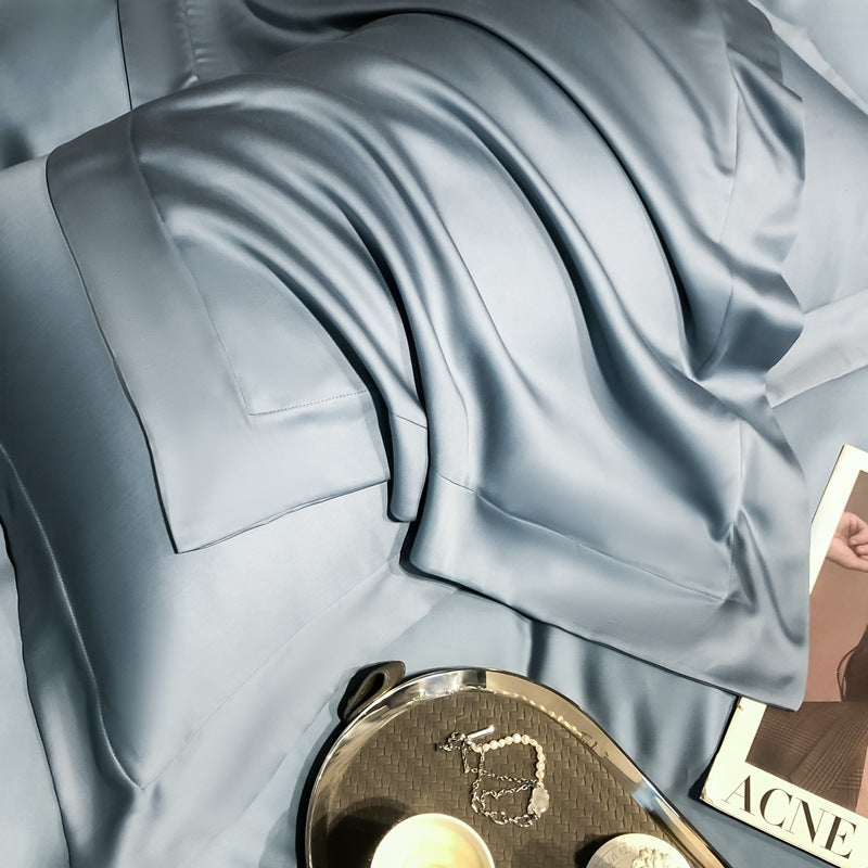 Blue silky Tencel Lyocell cooling pillowcase and bedding on bed, StuffedHome luxury linens