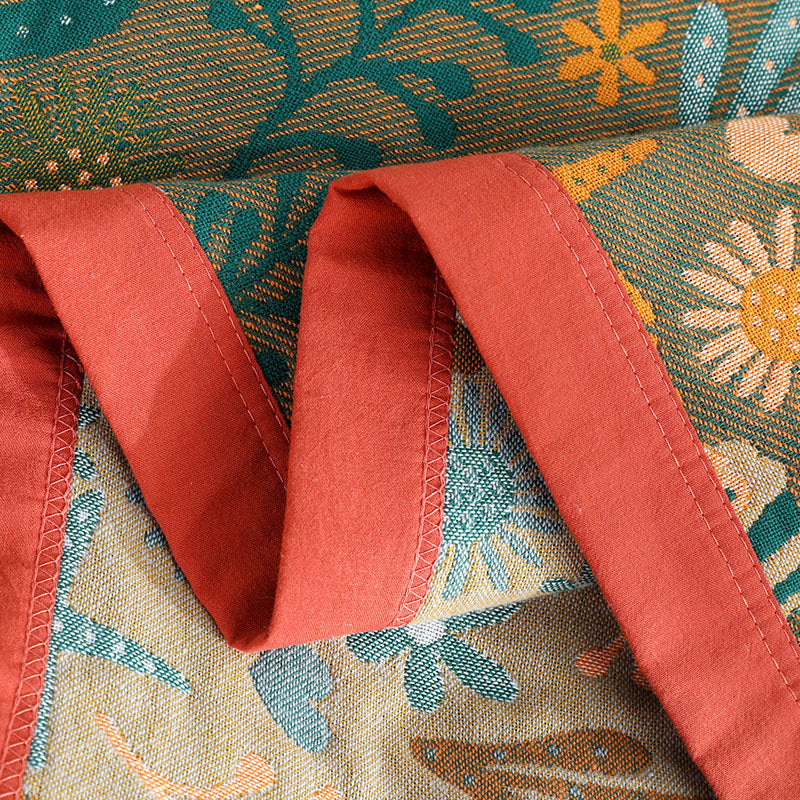 Detailed view of the red stitched border and high-density cotton weave of the ocean themed reversible jacquard throw blanket.