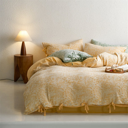 Warm yellow botanical jacquard bedding set styled in natural light with cozy layers