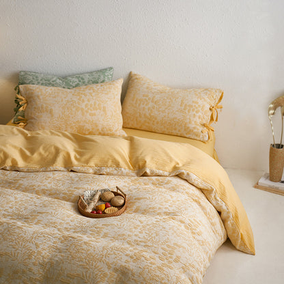 Yellow jacquard pillow close-up highlighting floral texture and decorative ties